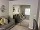 Bedroom with mirror closet reflecting gray sofa adorned with decorative pillows at 4242 N 27Th St # 2, Phoenix, AZ 85016