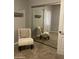 Bedroom with chair and mirrored closet doors reflecting the interior at 4242 N 27Th St # 2, Phoenix, AZ 85016