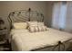 Bedroom with a wrought iron bed frame and white linens and side table at 4242 N 27Th St # 2, Phoenix, AZ 85016