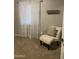 Bedroom with seating area, sheer curtains, and neutral colored walls and flooring at 4242 N 27Th St # 2, Phoenix, AZ 85016