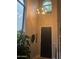 Inviting entryway with a modern chandelier, large windows, and a stylish black front door at 4242 N 27Th St # 2, Phoenix, AZ 85016