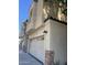 Townhome with white garage doors and exterior stone accents under blue sky at 4242 N 27Th St # 2, Phoenix, AZ 85016