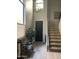 Bright foyer featuring stairs, a black front door, chandelier, large window and decorative plant at 4242 N 27Th St # 2, Phoenix, AZ 85016