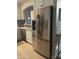Kitchen featuring stainless steel refrigerator, granite counters, subway tile, and white cabinets at 4242 N 27Th St # 2, Phoenix, AZ 85016