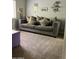 Comfortable living room featuring a plush gray sofa adorned with decorative pillows at 4242 N 27Th St # 2, Phoenix, AZ 85016