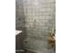 Sleek shower with gray subway tile, glass door, and mosaic floor, complemented by stylish fixtures at 4242 N 27Th St # 2, Phoenix, AZ 85016