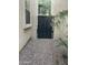 Side yard view showcasing gravel, gate and stucco wall at 4242 N 27Th St # 2, Phoenix, AZ 85016