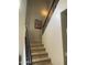 Interior staircase showcasing black iron railings and carpeted steps, with decorative art at 4242 N 27Th St # 2, Phoenix, AZ 85016
