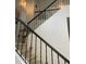 Interior staircase showcasing black iron railings and carpeted steps, with decorative art at 4242 N 27Th St # 2, Phoenix, AZ 85016