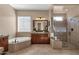 Spacious bathroom with a soaking tub, glass-enclosed shower, and vanity at 4249 E Nightingale Ln, Gilbert, AZ 85298