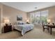 Bright bedroom featuring a large window, desk, and a cozy queen-sized bed at 4249 E Nightingale Ln, Gilbert, AZ 85298