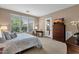 Well-lit bedroom with carpet, large window, TV, and access to the outdoors at 4249 E Nightingale Ln, Gilbert, AZ 85298
