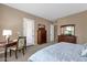Well-lit carpeted bedroom with access to a patio and an ensuite at 4249 E Nightingale Ln, Gilbert, AZ 85298