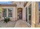 Home entry showcasing an arched entryway, decorative wreath, and sidelight window for added natural light at 4249 E Nightingale Ln, Gilbert, AZ 85298