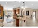 Open concept kitchen featuring a functional island, warm lighting, and seamless flow to dining area at 4249 E Nightingale Ln, Gilbert, AZ 85298