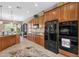 Well-equipped kitchen with black appliances, ample cabinetry, and smooth transitions to other living spaces at 4249 E Nightingale Ln, Gilbert, AZ 85298