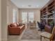 Comfortable home office with built-in bookshelves, neutral paint and ample natural light creates a productive workspace at 4249 E Nightingale Ln, Gilbert, AZ 85298