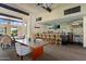 Well-lit bar area with stools, tables, chairs, and TVs, ideal for relaxing and socializing at 4800 N 68Th St # 270, Scottsdale, AZ 85251
