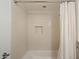 Clean bathroom with a shower-tub combo, white tile, and a recessed storage niche at 4800 N 68Th St # 270, Scottsdale, AZ 85251