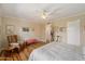 A sunlit bedroom with wood floors, neutral walls, and a cozy seating area at 4800 N 68Th St # 270, Scottsdale, AZ 85251