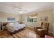 Inviting bedroom with a brick accent wall, hardwood floors, and ample natural light at 4800 N 68Th St # 270, Scottsdale, AZ 85251