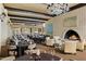 Elegant dining room featuring a fireplace, well-set tables, chairs, and large windows at 4800 N 68Th St # 270, Scottsdale, AZ 85251