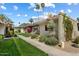 Inviting home exterior with desert landscaping and palm trees, with mountain views in the background at 4800 N 68Th St # 270, Scottsdale, AZ 85251