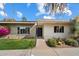 Welcoming home exterior with well-maintained desert landscaping, a brick facade and screened front door at 4800 N 68Th St # 270, Scottsdale, AZ 85251