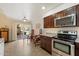 Bright kitchen with stainless steel appliances, dark wood cabinets, and a view of the patio at 4800 N 68Th St # 270, Scottsdale, AZ 85251