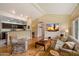 Open concept living room with vaulted ceilings, hardwood floors, and modern media setup at 4800 N 68Th St # 270, Scottsdale, AZ 85251