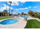 Serene pool and spa area with lounge chairs, palm trees, and lush landscaping, perfect for relaxation at 4800 N 68Th St # 270, Scottsdale, AZ 85251