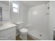 Clean, white bathroom features a shower, toilet, and sink with vanity at 492 W 17Th Ave, Apache Junction, AZ 85120