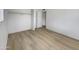 Bright bedroom features white walls, wood-look floors, closet, and an interior door at 492 W 17Th Ave, Apache Junction, AZ 85120