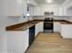 An efficient kitchen featuring stainless steel appliances, white cabinets, and neutral countertops at 492 W 17Th Ave, Apache Junction, AZ 85120