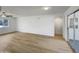 Open-concept living room boasts wood-look floors, modern lighting, and sliding glass door at 492 W 17Th Ave, Apache Junction, AZ 85120