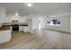 Open concept living room and kitchen area with hardwood floors and bright white walls at 492 W 17Th Ave, Apache Junction, AZ 85120