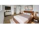 Comfortable main bedroom with a wooden bed frame, stylish decor, and a mounted TV at 492 W 17Th Ave, Apache Junction, AZ 85120