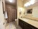 Bright bathroom with a granite countertop, dark wood cabinets, and decorative tiling at 4925 E Desert Cove Ave # 236, Scottsdale, AZ 85254