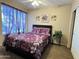 This bedroom features a bed with floral pattern bedding and purple curtains at 4925 E Desert Cove Ave # 236, Scottsdale, AZ 85254
