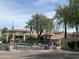 Gated community entrance with lush landscaping and desert rock features at 4925 E Desert Cove Ave # 236, Scottsdale, AZ 85254