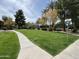 Well-maintained community green space featuring lush grass and a walking path at 4925 E Desert Cove Ave # 236, Scottsdale, AZ 85254