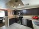 Well-lit kitchen featuring stainless steel appliances, dark cabinets, and granite countertops at 4925 E Desert Cove Ave # 236, Scottsdale, AZ 85254