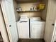 Functional laundry area with a washing machine, dryer, and overhead shelf storage at 4925 E Desert Cove Ave # 236, Scottsdale, AZ 85254