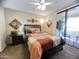 A well-lit main bedroom featuring a sliding glass door to a covered patio and neutral wall color at 4925 E Desert Cove Ave # 236, Scottsdale, AZ 85254