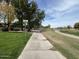 Community walking path bordering a lush green space and golf course at 4925 E Desert Cove Ave # 236, Scottsdale, AZ 85254