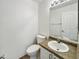 Bright bathroom featuring a modern sink, white cabinets, and a large mirror at 540 W Palo Verde St, Casa Grande, AZ 85122