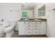 Bathroom with double sinks, white cabinets, and large vanity mirror at 540 W Palo Verde St, Casa Grande, AZ 85122