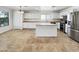Spacious kitchen with stainless steel appliances, white cabinets, and kitchen island at 540 W Palo Verde St, Casa Grande, AZ 85122
