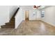 Bright living room with tile floors, ceiling fan, and staircase leading upstairs at 540 W Palo Verde St, Casa Grande, AZ 85122