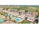 Aerial view showcasing a well-planned neighborhood with pools and proximity to green fields at 565 E Rosebud Dr, San Tan Valley, AZ 85143